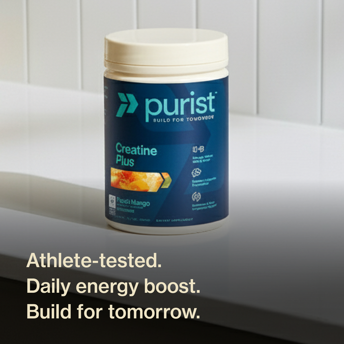 Purist® Creatine Plus container on white counter top with a white back splash. athlete tested. daily energy boost. build for tomorrow.