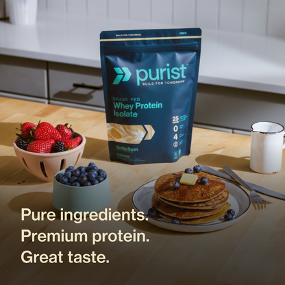 Purist® whey protein isolate package on a kitchen counter with pancakes and berries. Pure ingredients. Premium protein. Great taste.