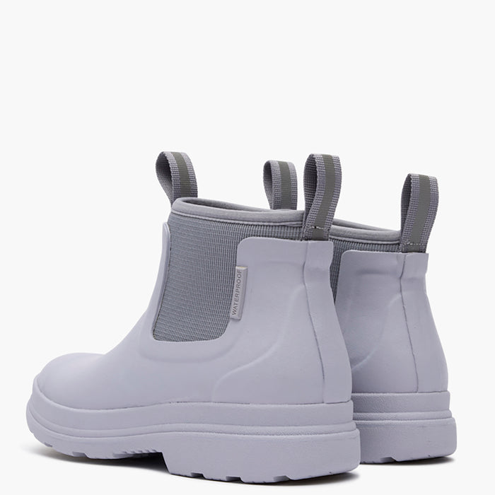 Pair of light gray rain boots with elastic sides on a white background