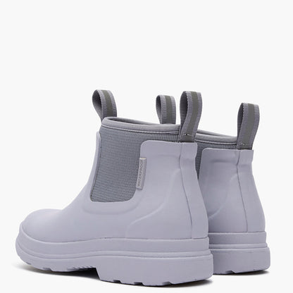 Pair of light gray rain boots with elastic sides on a white background