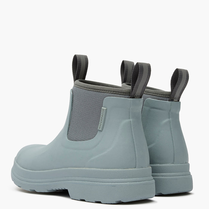 Pair of light blue rubber boots with gray elastic sides on a white background