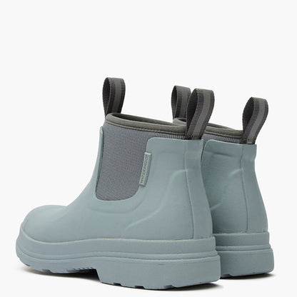 Pair of light blue rubber boots with gray elastic sides on a white background