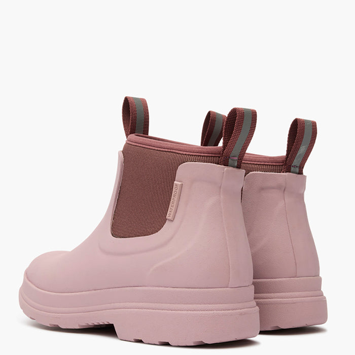 Pair of pink rubber boots with a white background