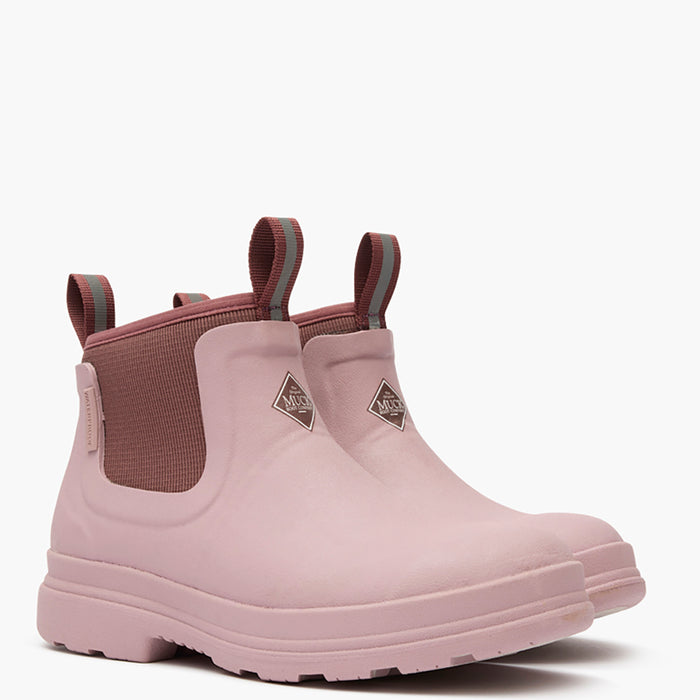 Pair of pink rubber boots with brown accents on a white background