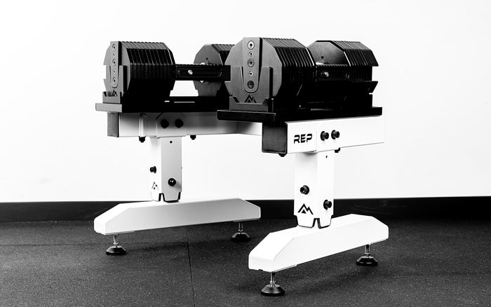 White REP® Adjustable Dumbbell Stand holding REP® x PÉPIN™ adjustable dumbbells