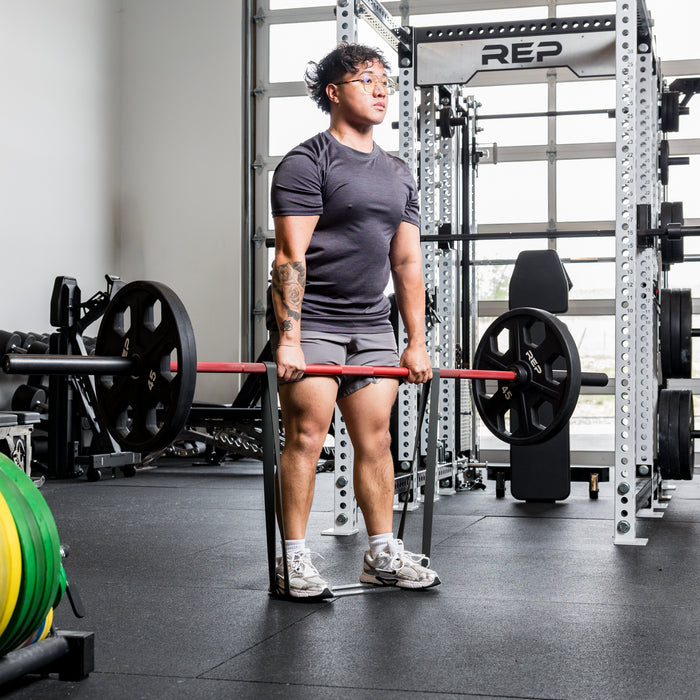 Athlete using the REP Fitness Resistance Bands 2.0 in deadlift lockout