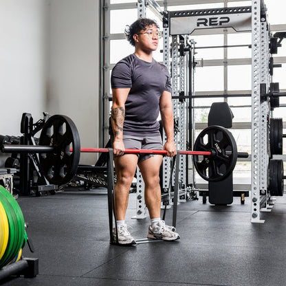 Athlete using the REP Fitness Resistance Bands 2.0 in deadlift lockout
