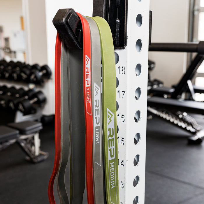 The REP Fitness Resistance Bands 2.0 hanging on rack