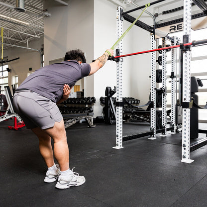 Athlete using the REP Fitness Resistance Bands 2.0 in standing band pulldown