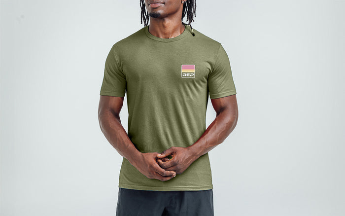 The REP Fitness Rise Tri-Blend Crew T-Shirt in Heather Olive/Red front, on model