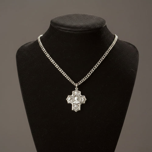 Silver chain necklace with a cross pendant on a black mannequin bust against a gray background