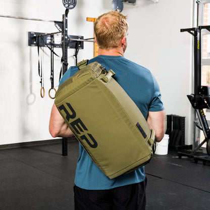 Athlete wearing the REP Fitness Slate Duffel Bag in Olive