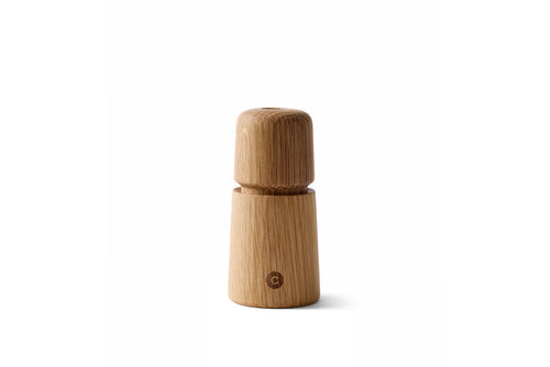 A beige oak wood manual grinder with a 'S' or 'P' indicator on the lid, designed for grinding salt, pepper, or spices.