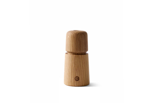 A beige oak wood manual grinder with a 'S' or 'P' indicator on the lid, designed for grinding salt, pepper, or spices.