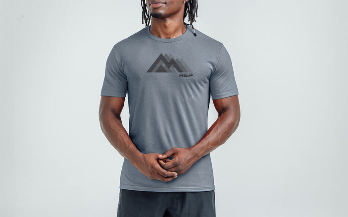 The REP Fitness Summit Tri-Blend Crew T-Shirt in Heather Flint/Black front, on model