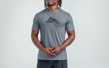 The REP Fitness Summit Tri-Blend Crew T-Shirt in Heather Flint/Black front, on model