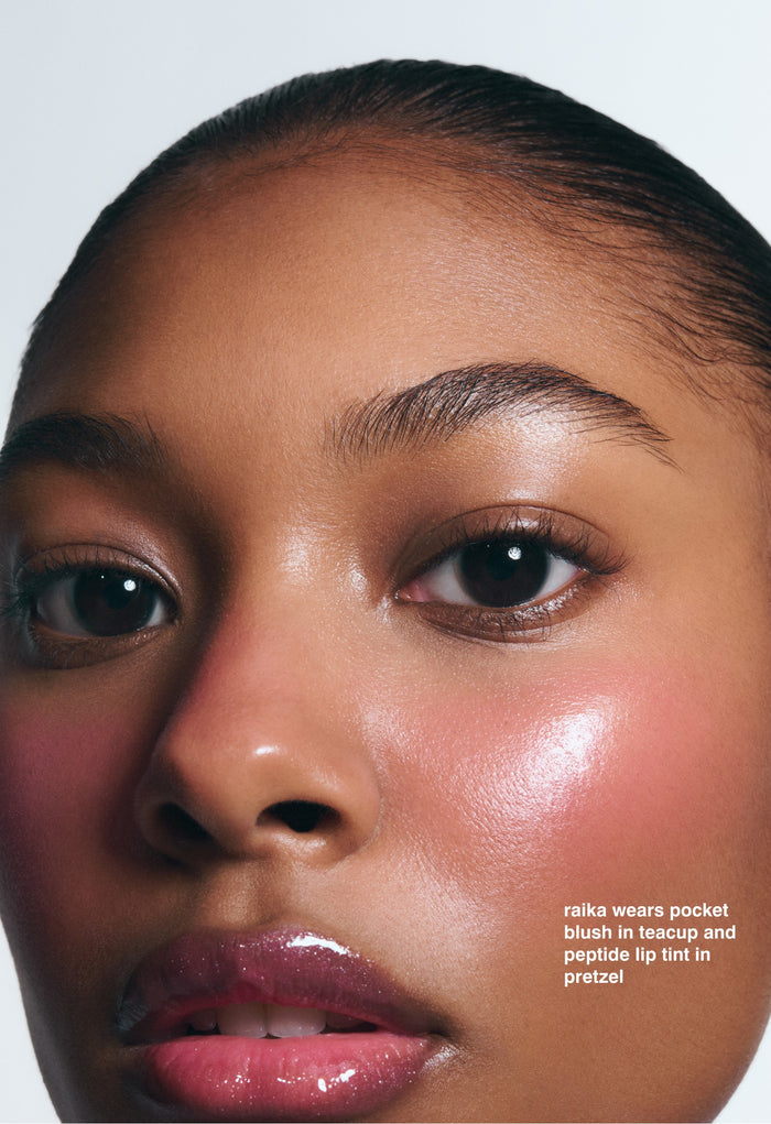raika wears pocket blush in teacup and peptide lip tint in pretzel