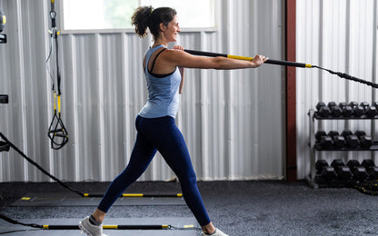 Side shot: Athlete working out with the TRX® Rip Trainer™ extended in front of them