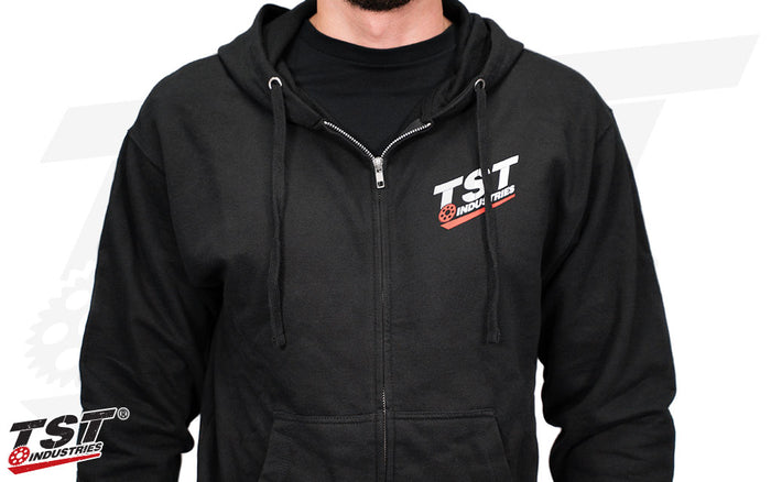 Black zip-up hoodie with our TST Industries logo screen printed on the front.