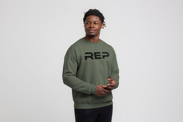 The REP Fitness Unisex Daily Driver Crewneck Sweatshirt in Olive/Black front, on model