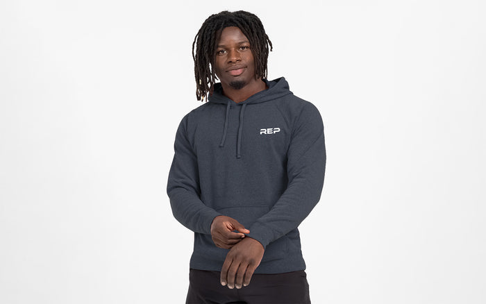 The REP Fitness Unisex USA Pull Over Hoodie in Heather Navy/White front, on model