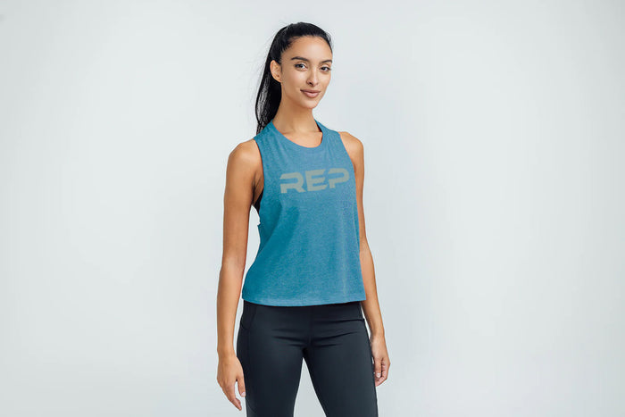 The REP Fitness Women's Daily Driver Cropped Dual-Blend Tank in Heather Teal/Aqua Gray on body