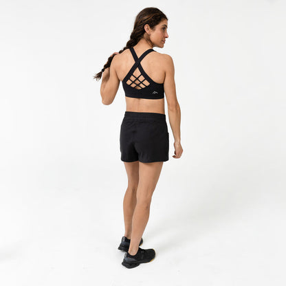 The REP Fitness Women's Lattis Sports Bra in Black back, posing