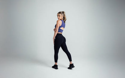 The REP Fitness Women's Rhea Cropped Tank Top in Dusk back, looking over shoulder
