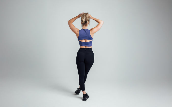The REP Fitness Women's Rhea Cropped Tank Top in Dusk back, arms overhead