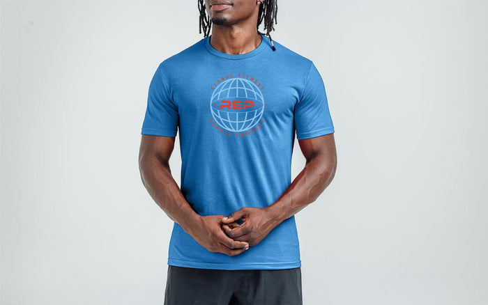 Athlete wearing the REP Fitness Worldwide Tri-Blend Crew T-Shirt in Heather Royal Blue with a light blue graphic