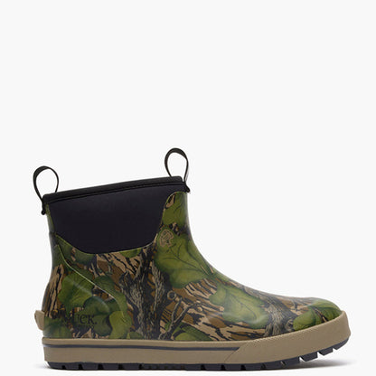 A single ankle-height rubber boot with a green and brown woodland camouflage pattern, a black elastic side panel with a pull tab, and a tan sole, shown against a plain white background.